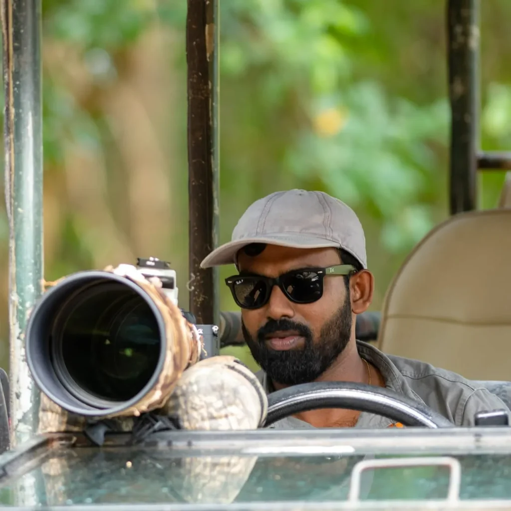 Visit Wilpattu safari guide driving a safari jeep with a professional wildlife camera setup in Wilpattu National Park